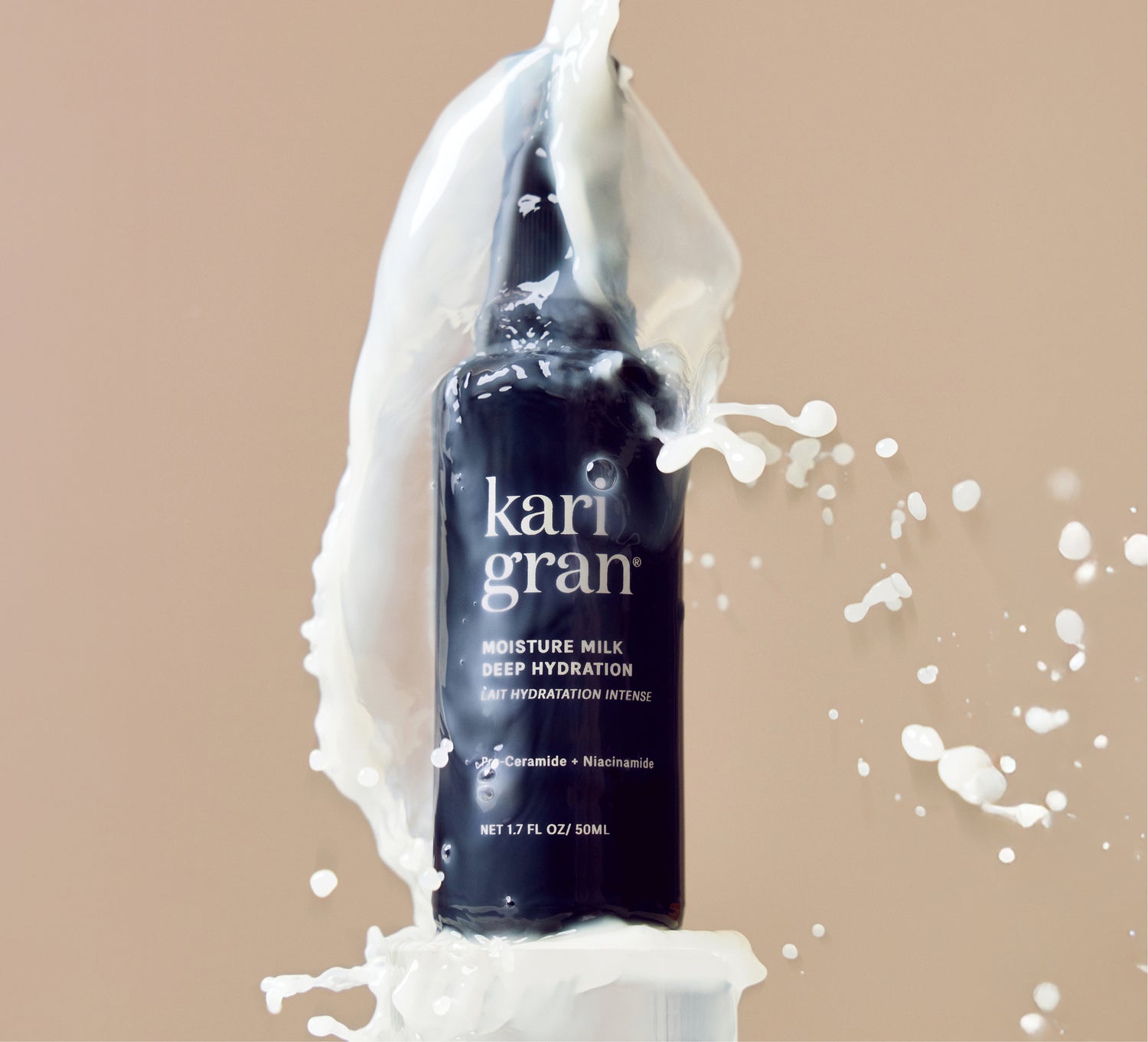 Kari Gran Moisture Milk bottle with white cream splashes on a beige background