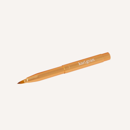 Lip brush with 'kari gran' branding on a white background