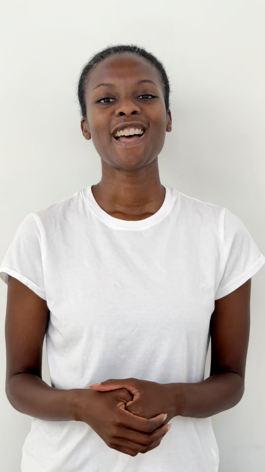 Person wearing a white t-shirt against a plain background